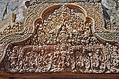 Banteay Srei temple - second enclosure, portico of the east gopura, a thick-breasted deity sits by two elephants with upraised trunks 